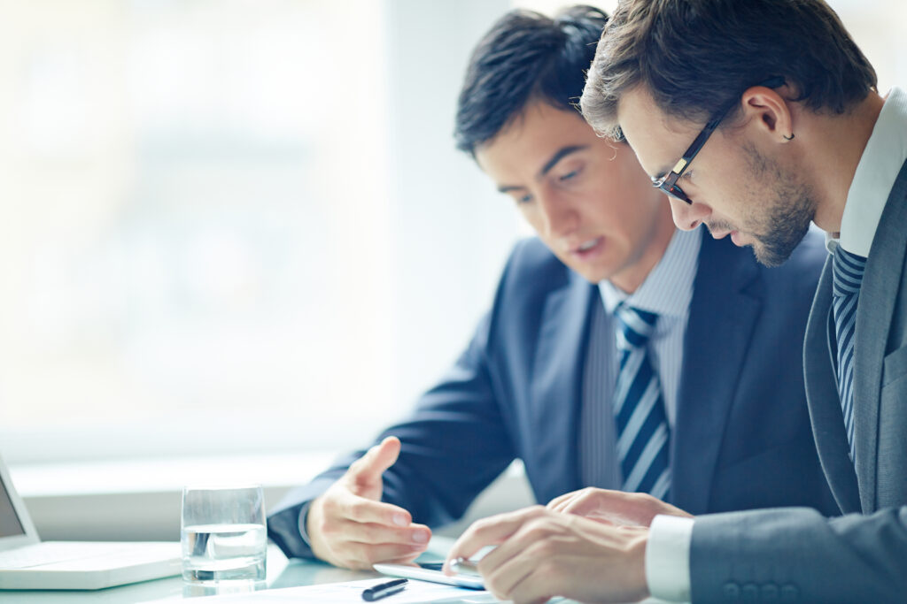 Two business professionals looking at documents
