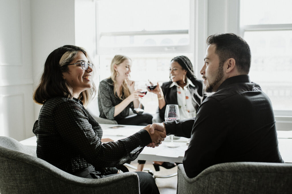 2020 search partners, A group of business professionals at a meeting, shaking hands